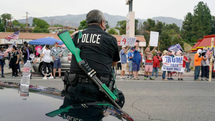A Los Angeles police officer faces Trump supporters during a pro Trump rally in Tujunga.