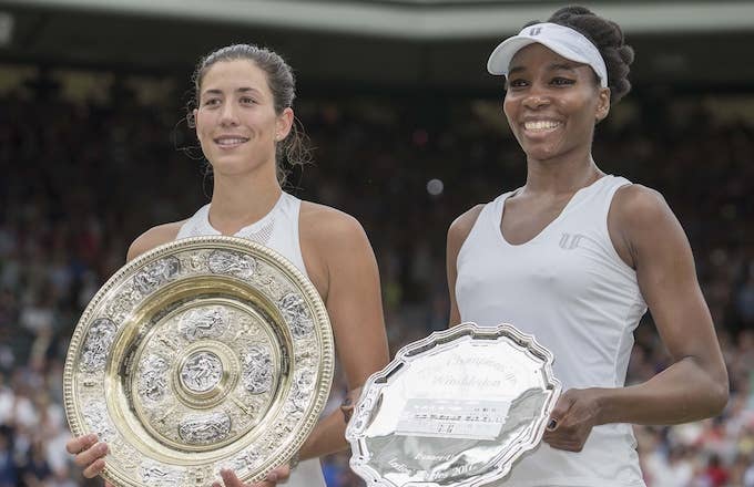 Venus Williams and Garbine Muguruza hold their Wimbledon hardware.