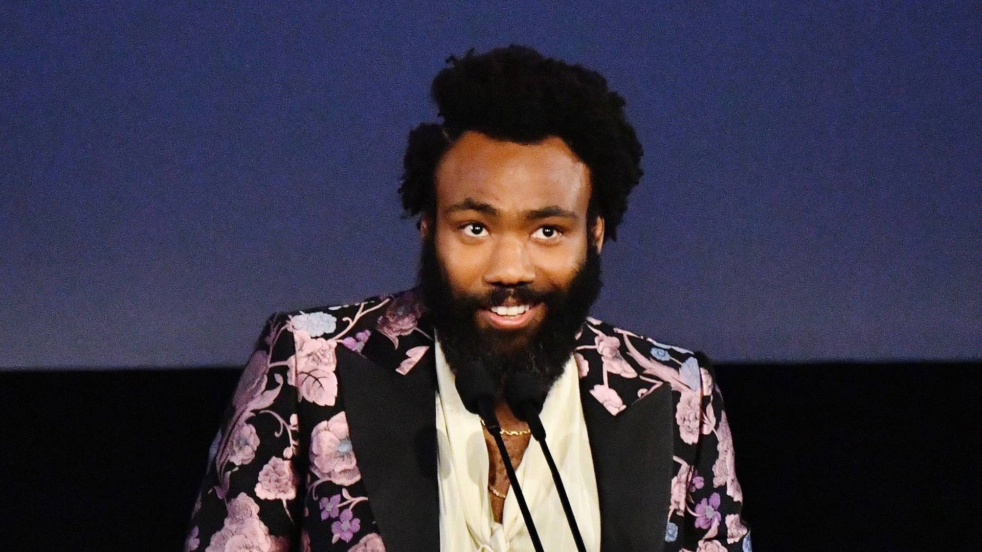 Donald Glover, wearing Gucci, speaks onstage during the 2019 LACMA Art + Film Gala