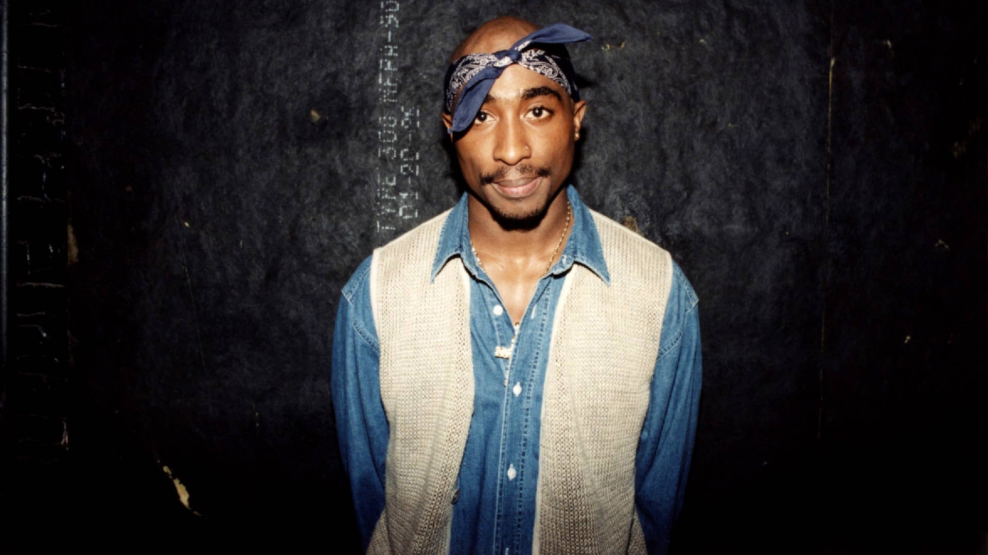 Tupac Shakur poses for photo backstage following performance.