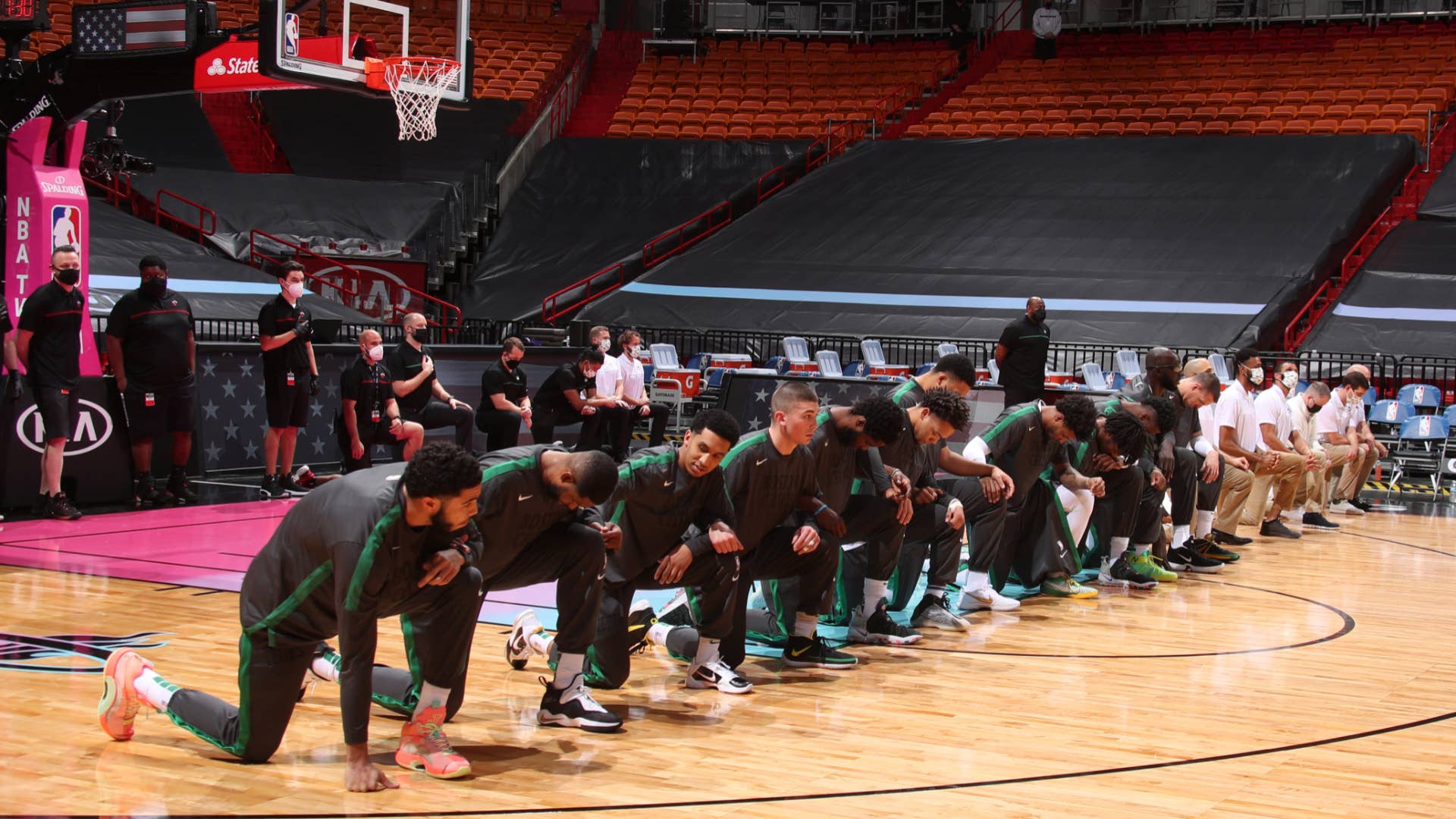 Celtics players look on during the national anthem before the game against the Heat.