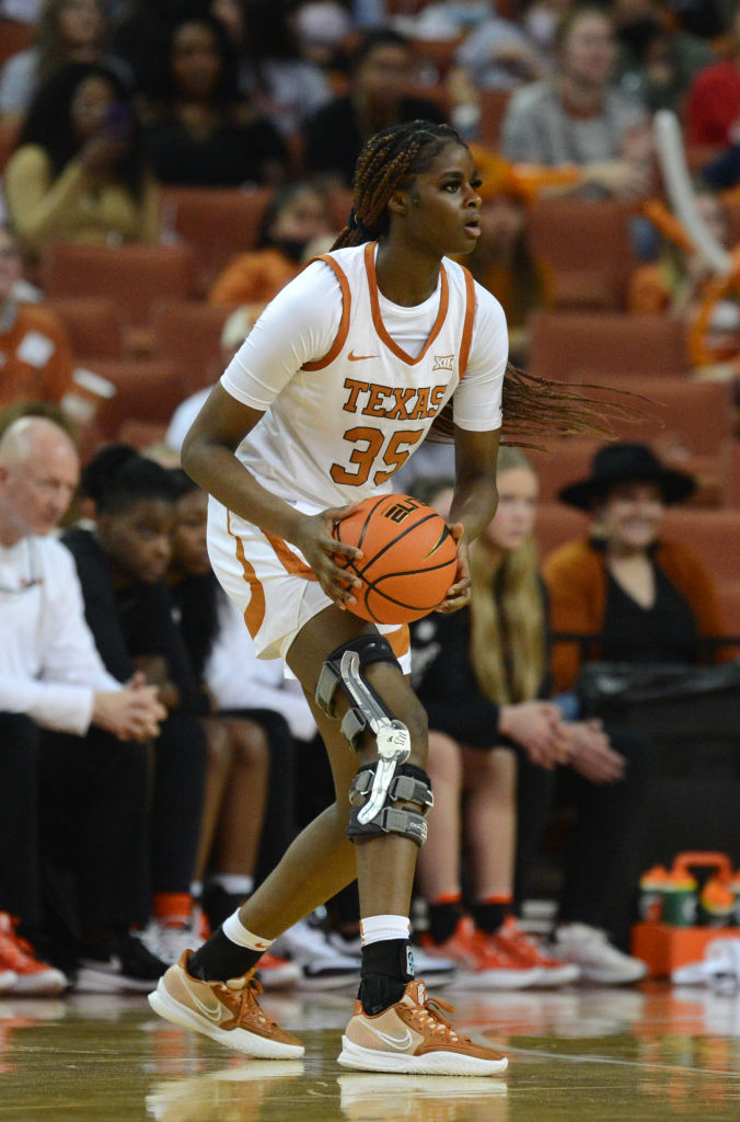 Latasha Lattimore holding the basketball at a UT game