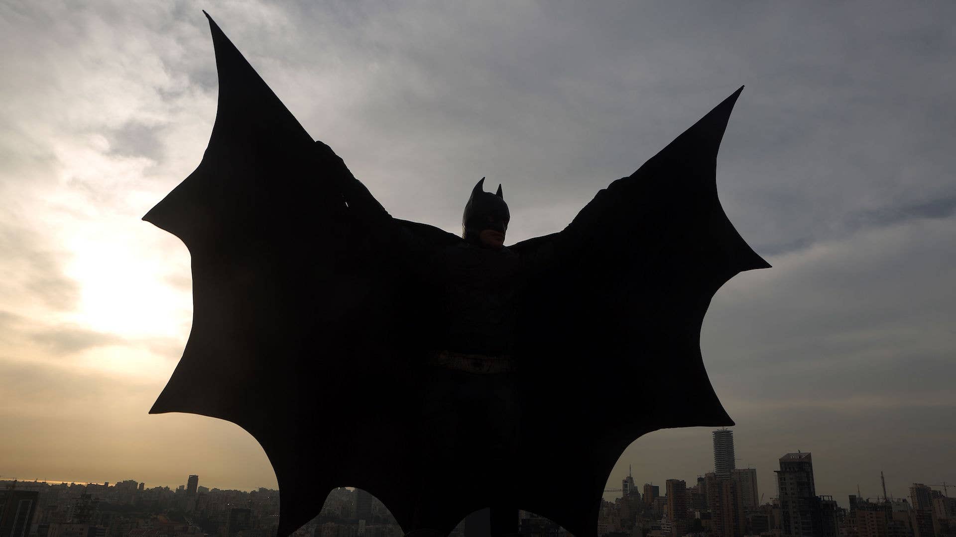 Lebanese model dressed as Batman on rooftop of building during a photoshoot in Beirut.