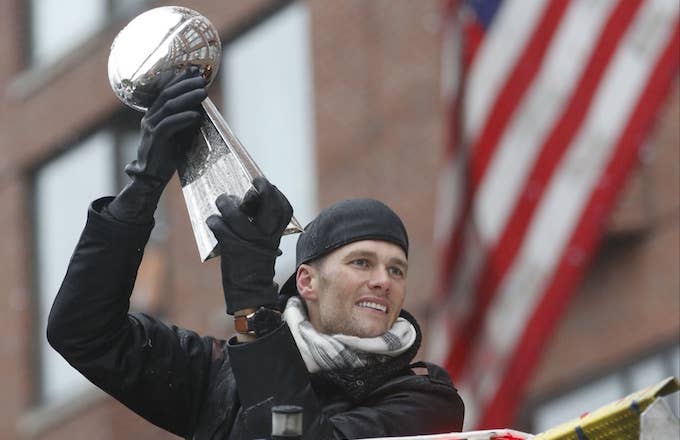 Tom Brady holds Super Bowl trophy at Patriots' championship parade.