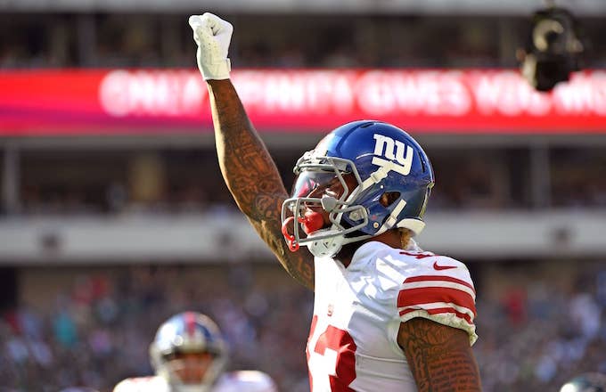 Odell Beckham celebrates by raising his fist in the air.