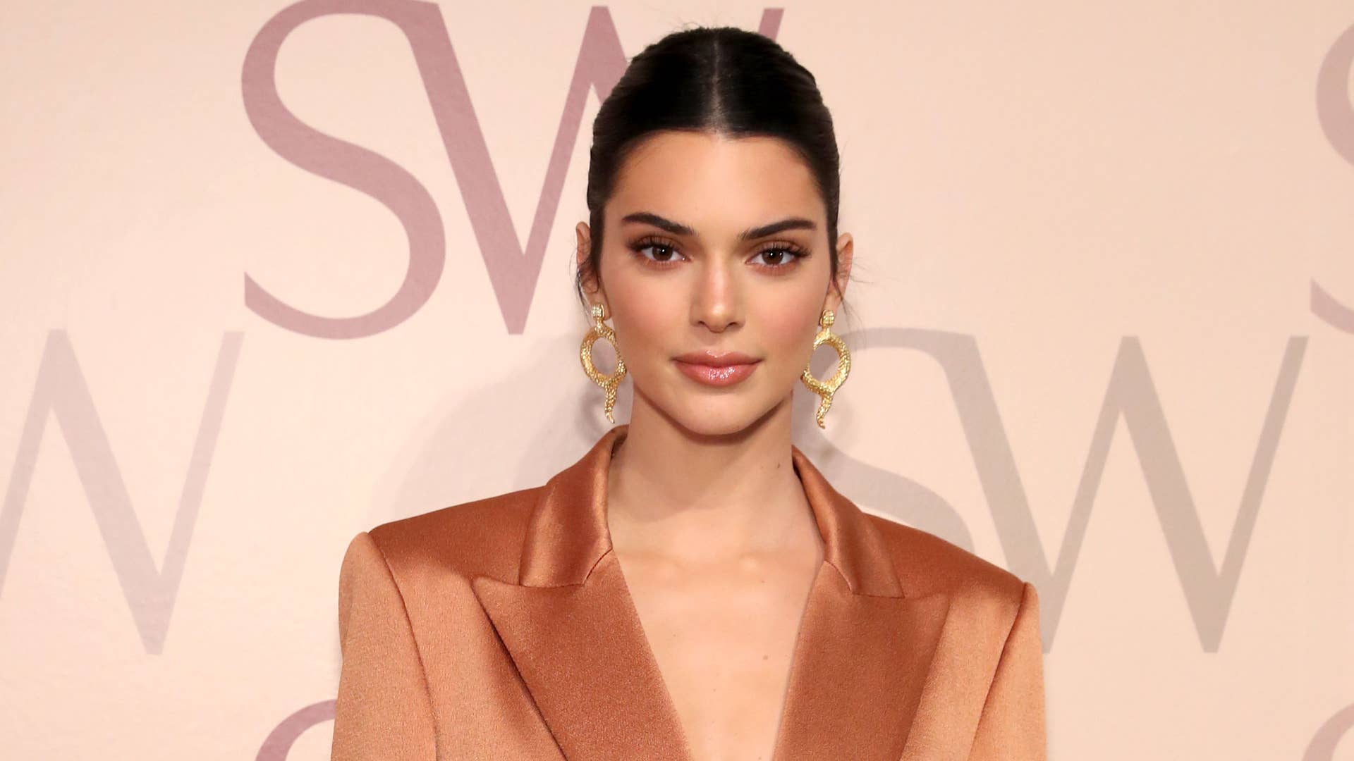 Kendall Jenner poses for photos at a fashion show.