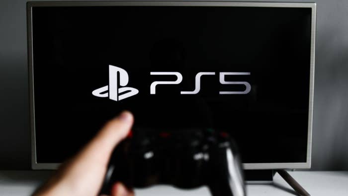 PlayStation 5 logo displayed on a tv screen and a gamepad