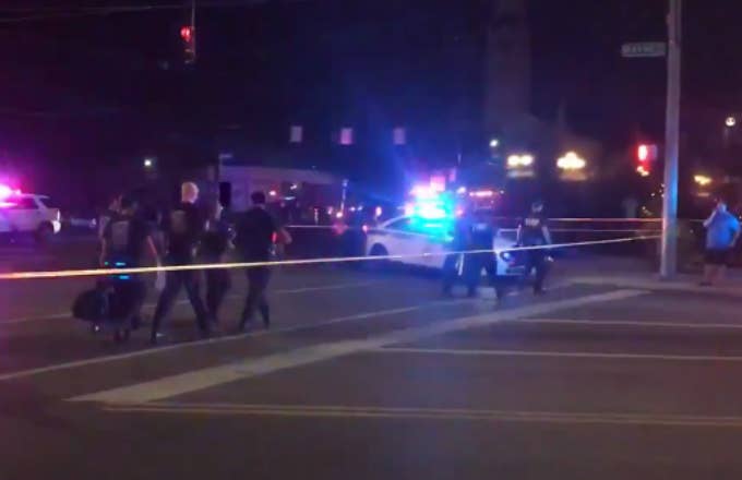 Police officers walking behind police cordon following a mass shooting