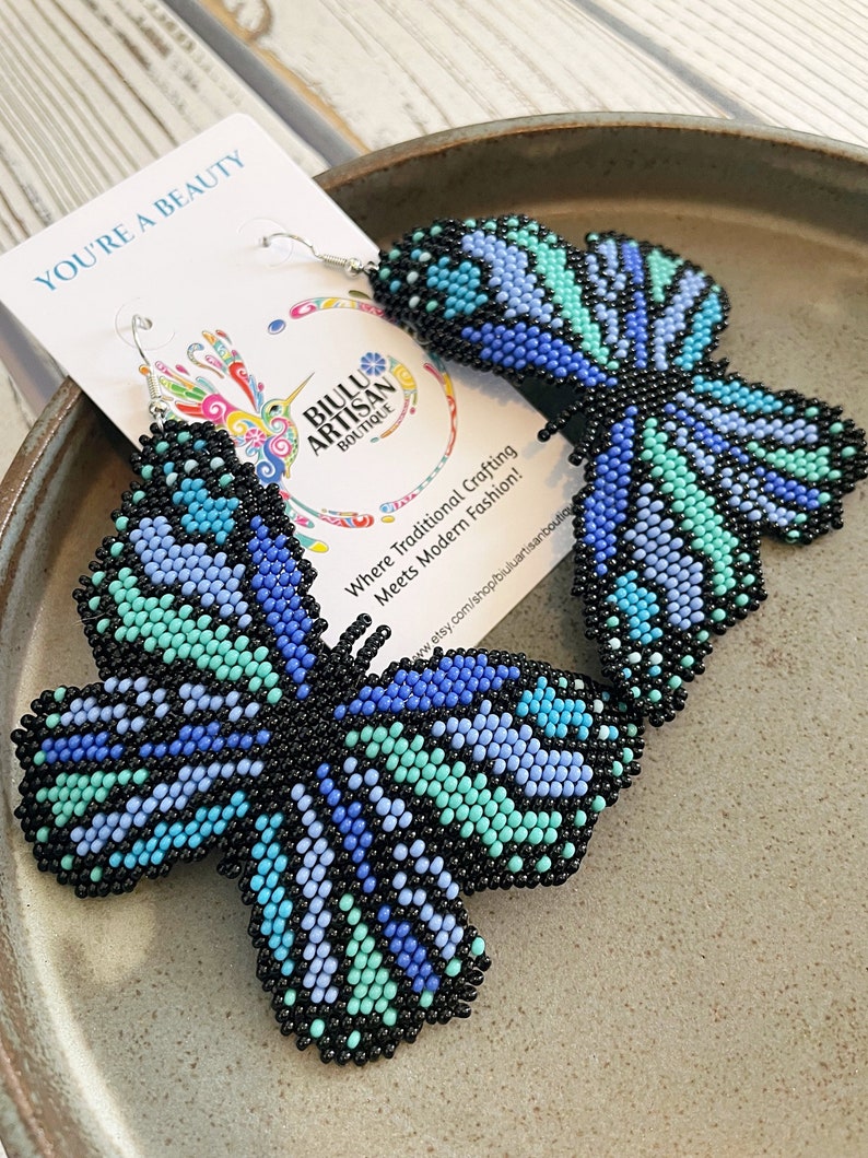 A pair of blue beadwork butterfly earrings from Biulu Artisan Boutique