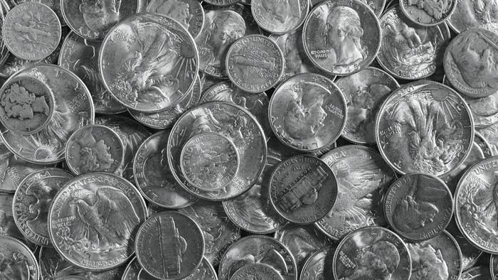 Pile of various old silver coins, close-up.