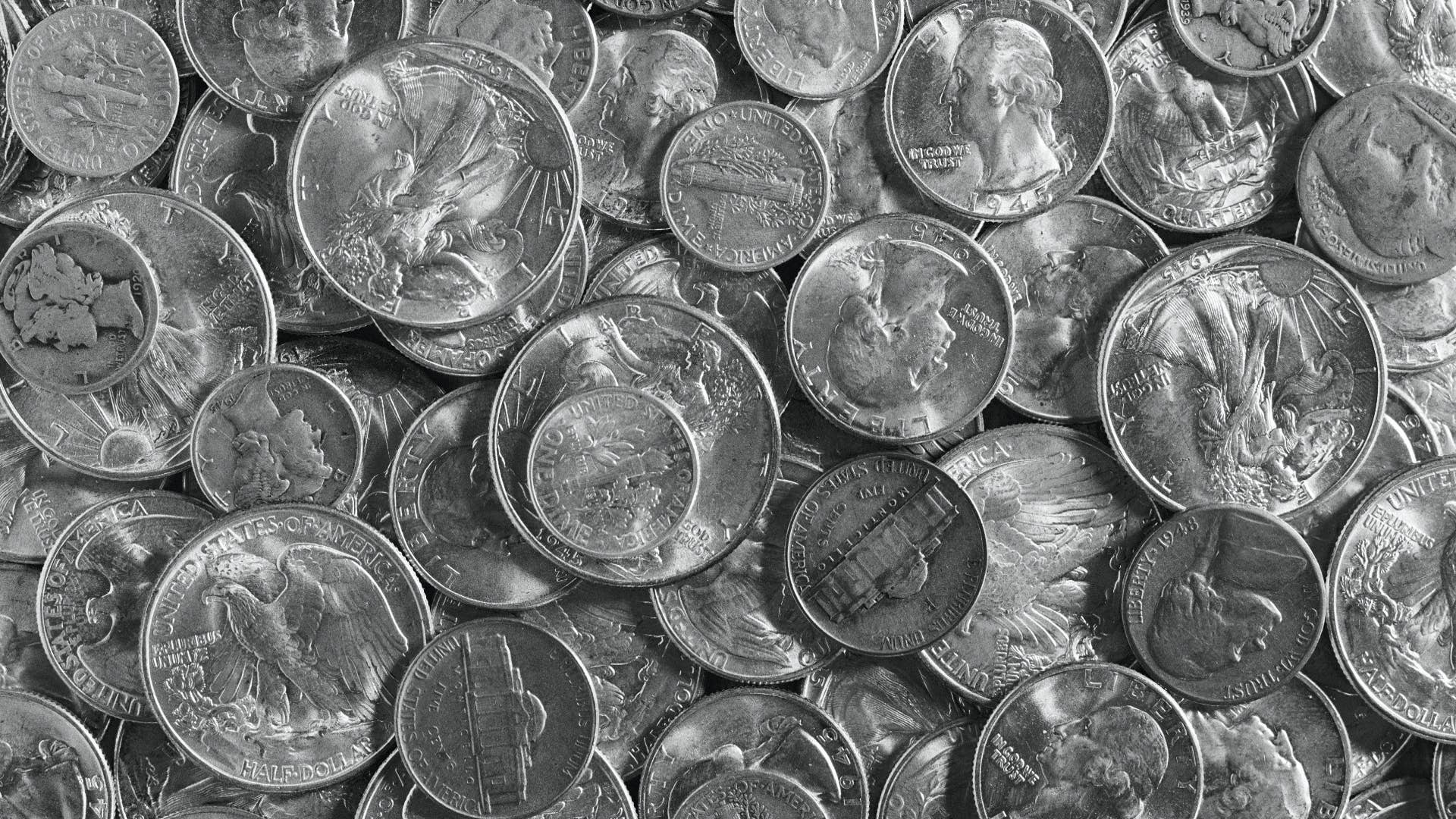 Pile of various old silver coins, close-up.