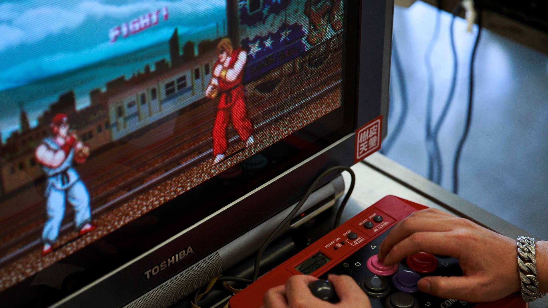 In this photo taken on August 12, 2017, a visitor plays the original 1980s Capcom classic Street Fighter, the precursor to the highly successful Street Fighter II sequel and later follow-ups.