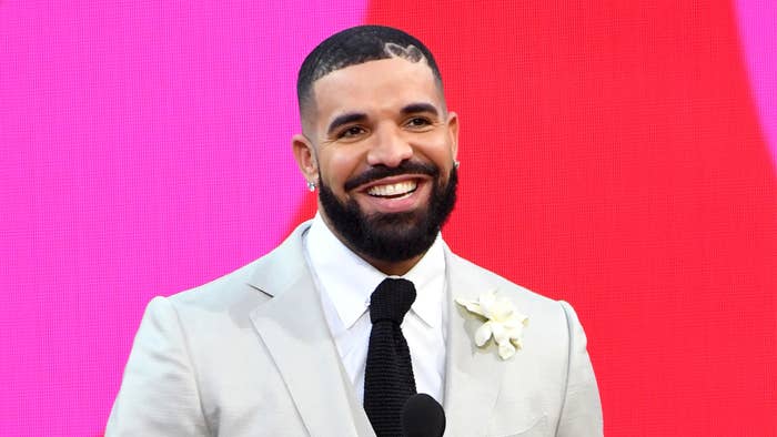 Drake, winner of the Artist of the Decade Award, and Adonis Graham speak onstage for the 2021 Billboard Music Awards, broadcast on May 23, 2021.