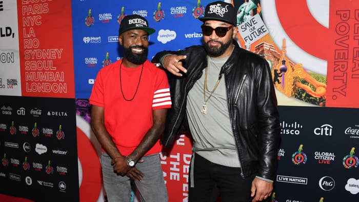 Desus and Mero are seen on a red carpet