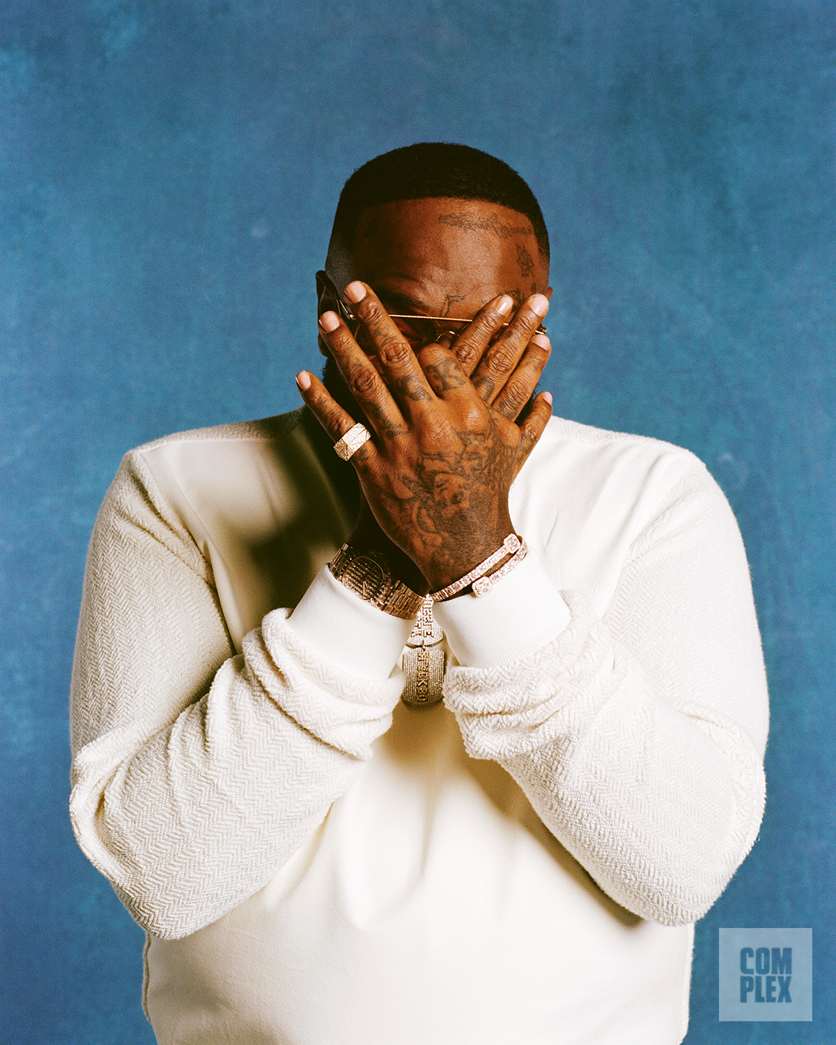 Rick Ross poses for his Complex interview