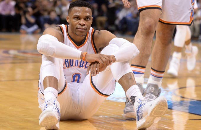 Russell Westbrook sits on the floor during a Thunder game.
