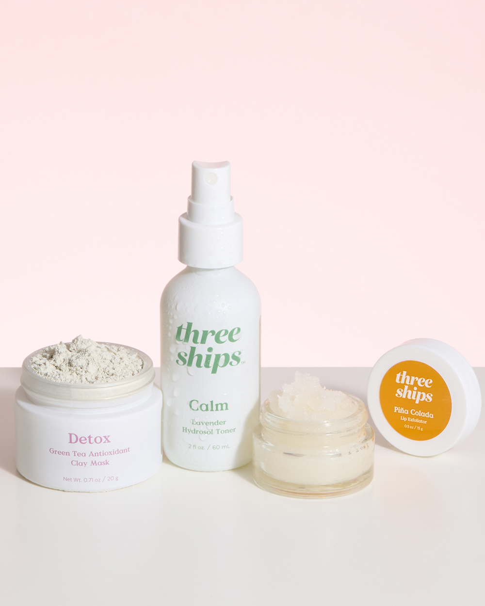 Some of Three Ships Beauty&#x27;s products modelled against a pink background