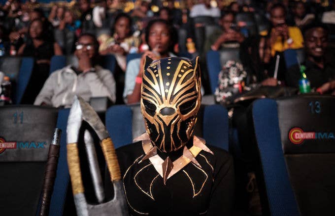 A cosplayer poses before watching the film 'Black Panther.'