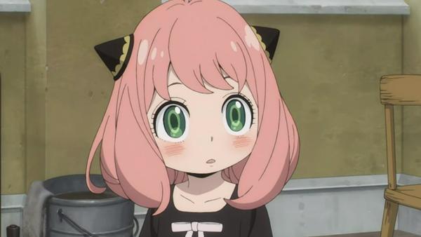 A girl with pink hair and green eyes stares wide-eyed.