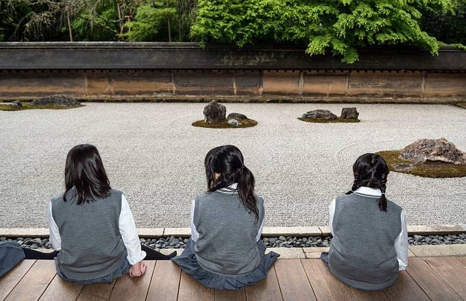 School girls at zen rock garden, Ryoanji, Ryoan ji Temple, Kyoto, Japan.