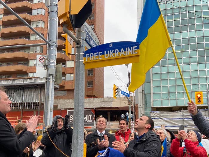 The unveiling of a blue and yellow &quot;Free Ukraine&quot; sign in Toronto, featuring Mayor john Tory among a crowd.