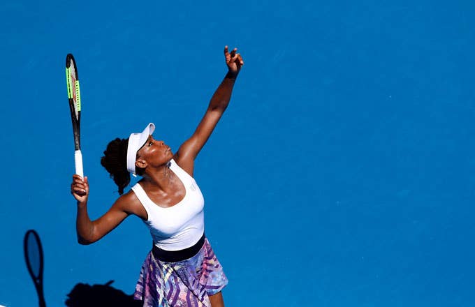 Venus Williams tosses up a serve.