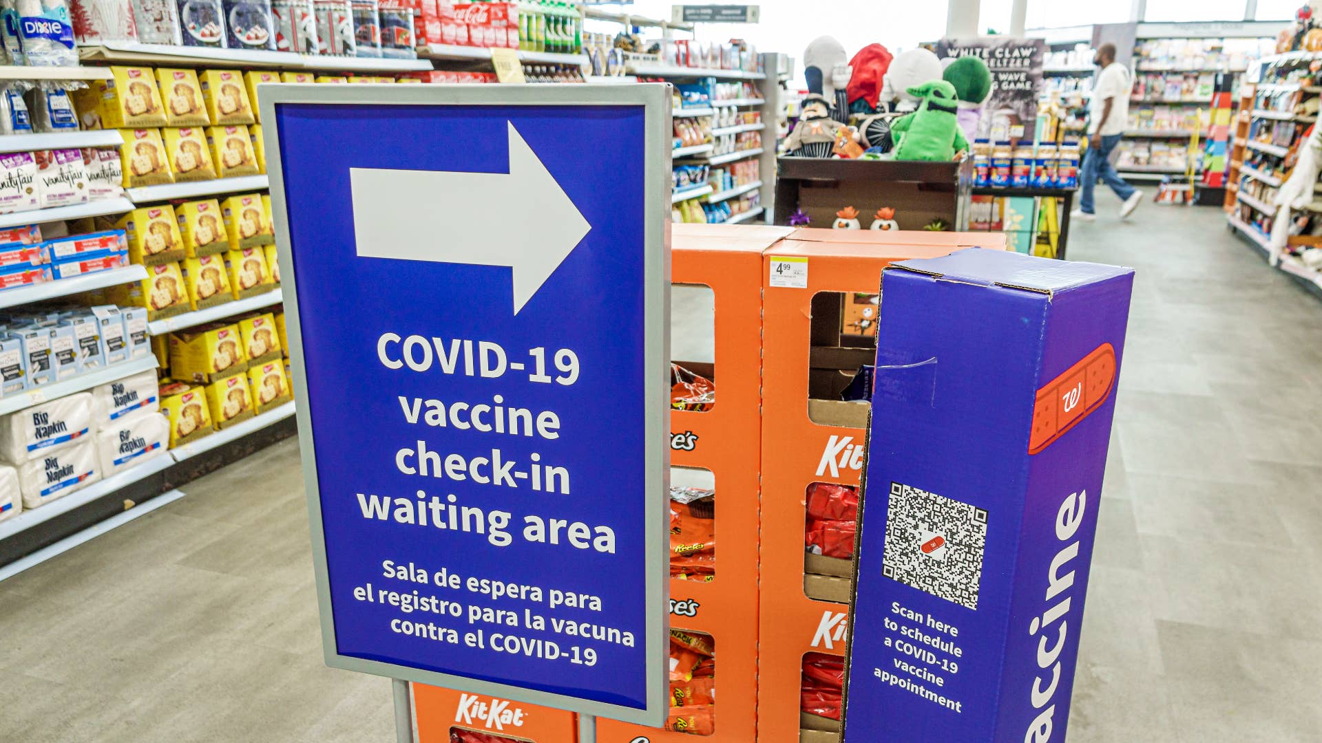 A COVID vaccine sign is seen in a store