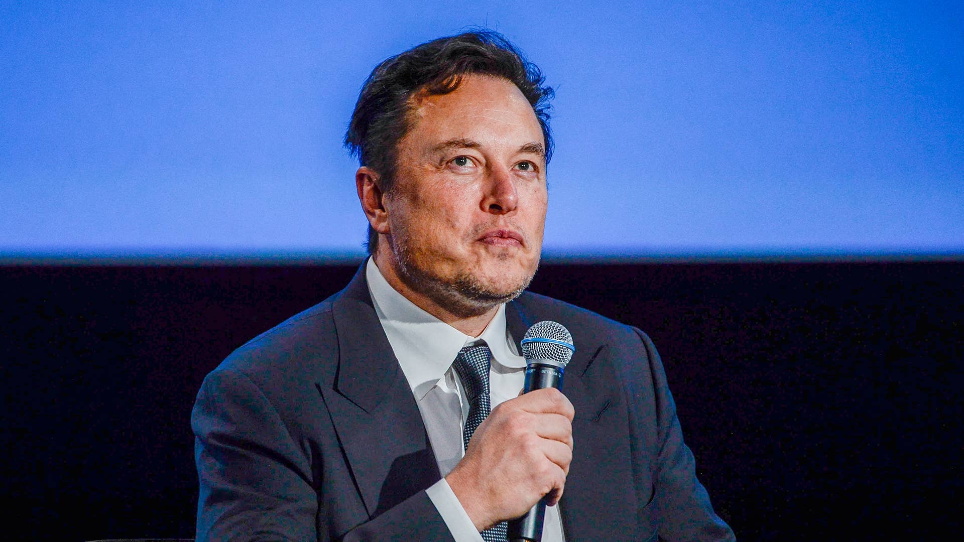 Tesla CEO Elon Musk looks up as he addresses guests at the Offshore Northern Seas 2022