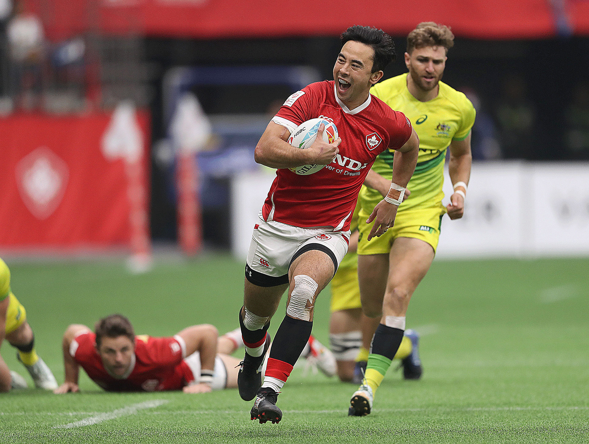 Nathan Hirayama #9 of Canada smiles as he breaks away during their semi final rugby sevens match against Australia at BC Place on March 08, 2020 in Vancouver, Canada.