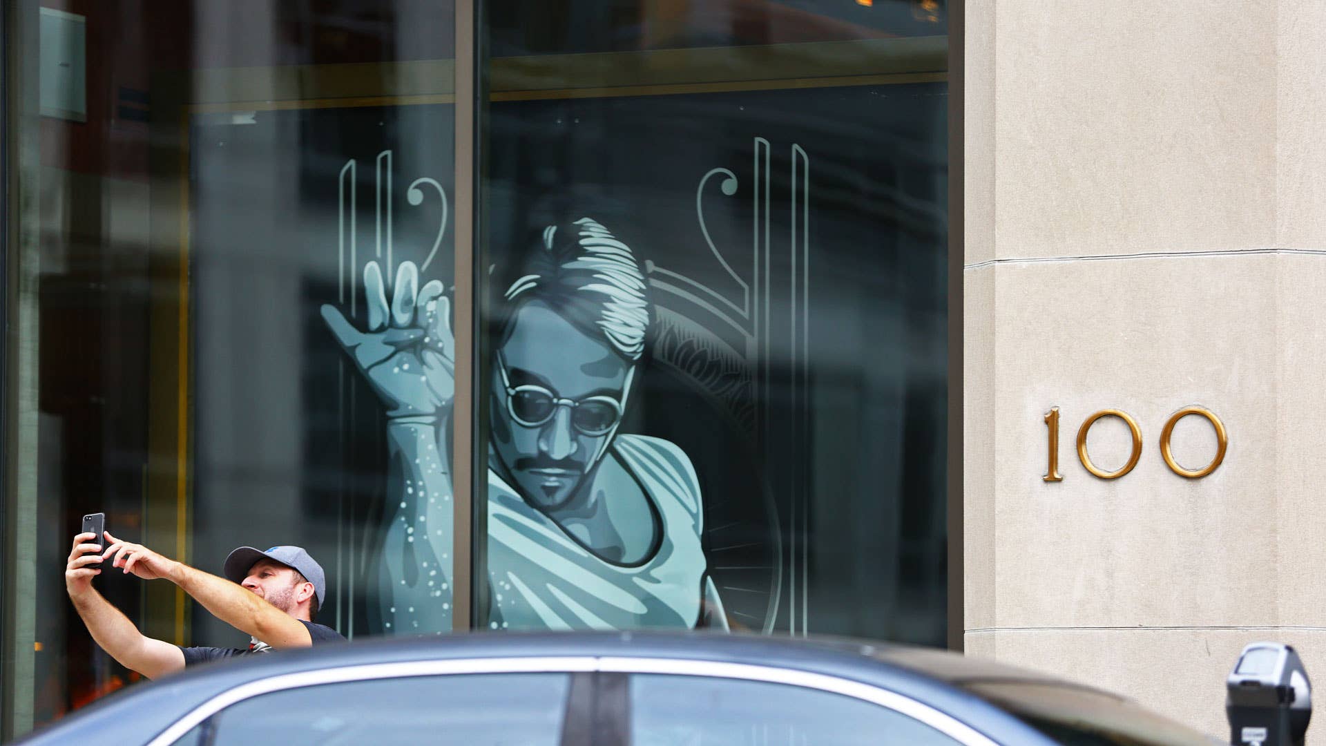 An unidentified man parks and takes a selfie next to the restaurant Nusr-Et.