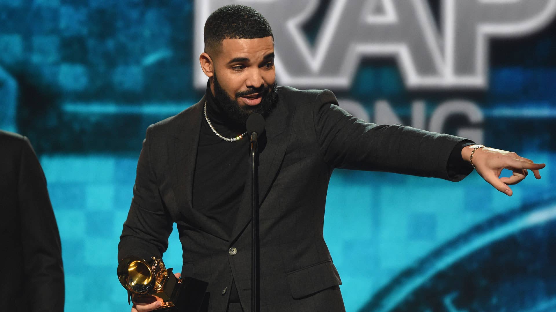 Drake accepting a Grammy Award for "Best Rap Song."