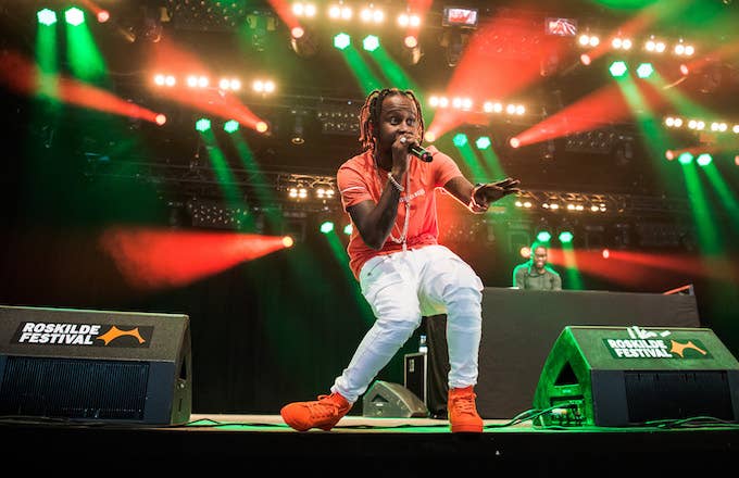 Popcaan performs on stage.