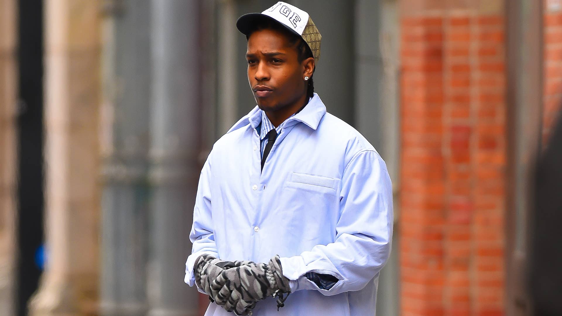 ASAP Rocky is pictured outside wearing gloves and a hat
