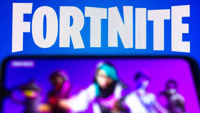 The Fortnite logo is seen on a smartphone and a PC screen.