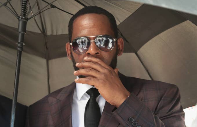 R&amp;B singer R. Kelly covers his mouth