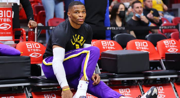 Russell Westbrook #0 of the Los Angeles Lakers laces up his shoes.