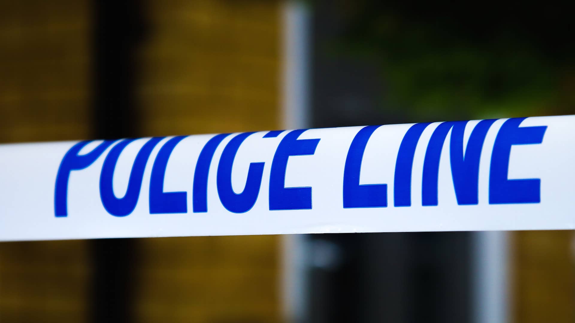 A police tape surrounds a crime scene
