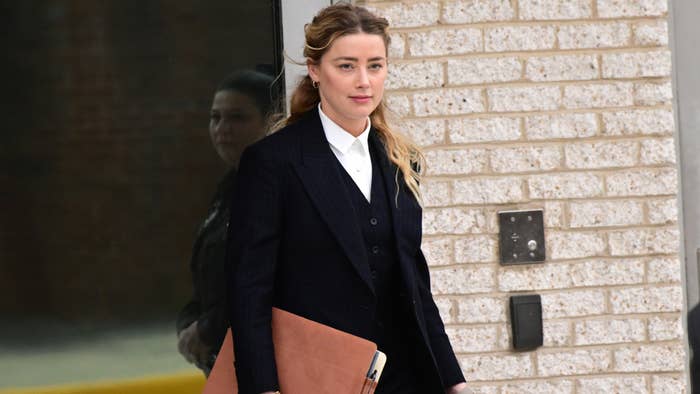 Amber Heard is pictured walking out of a court facility