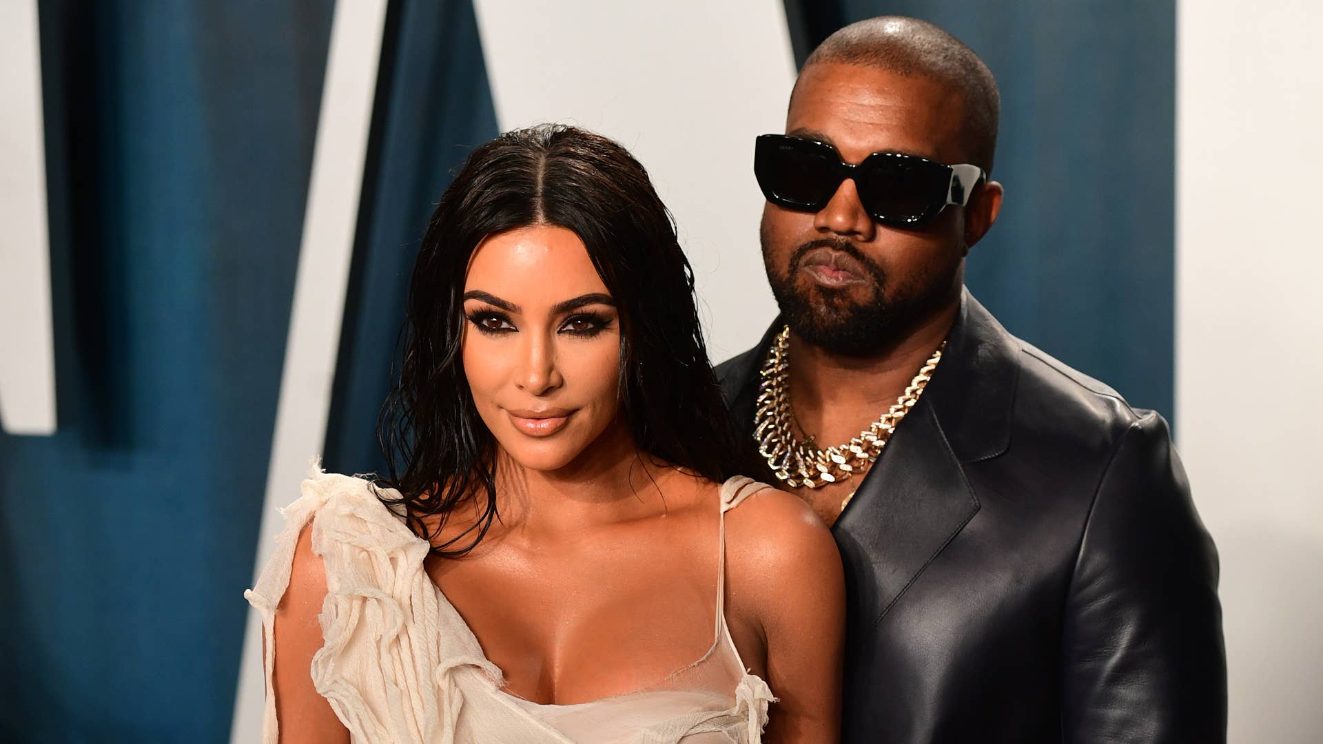 Kim Kardashian and Kanye West are pictured on a red carpet