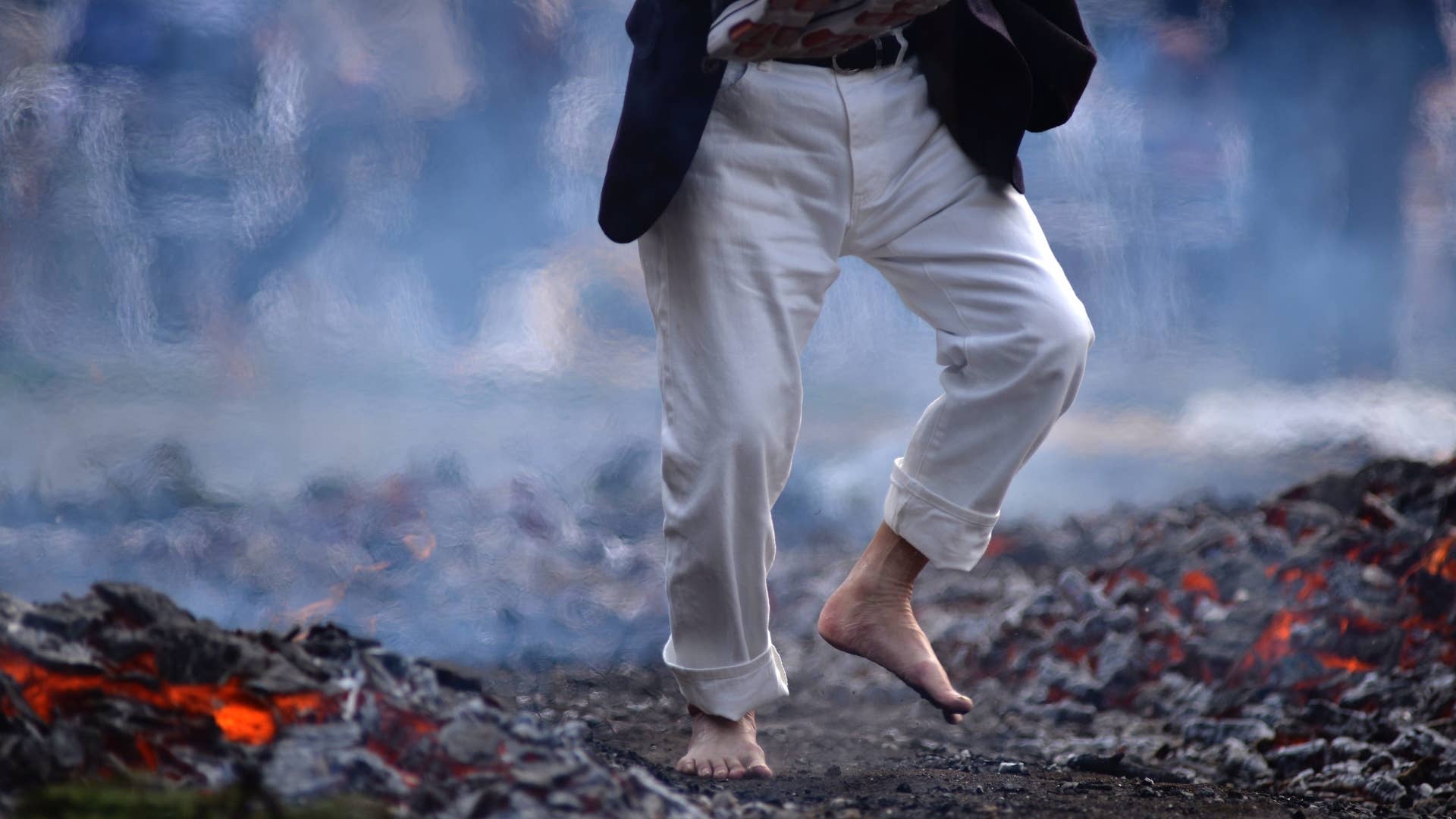 A photo of someone walking over coals.