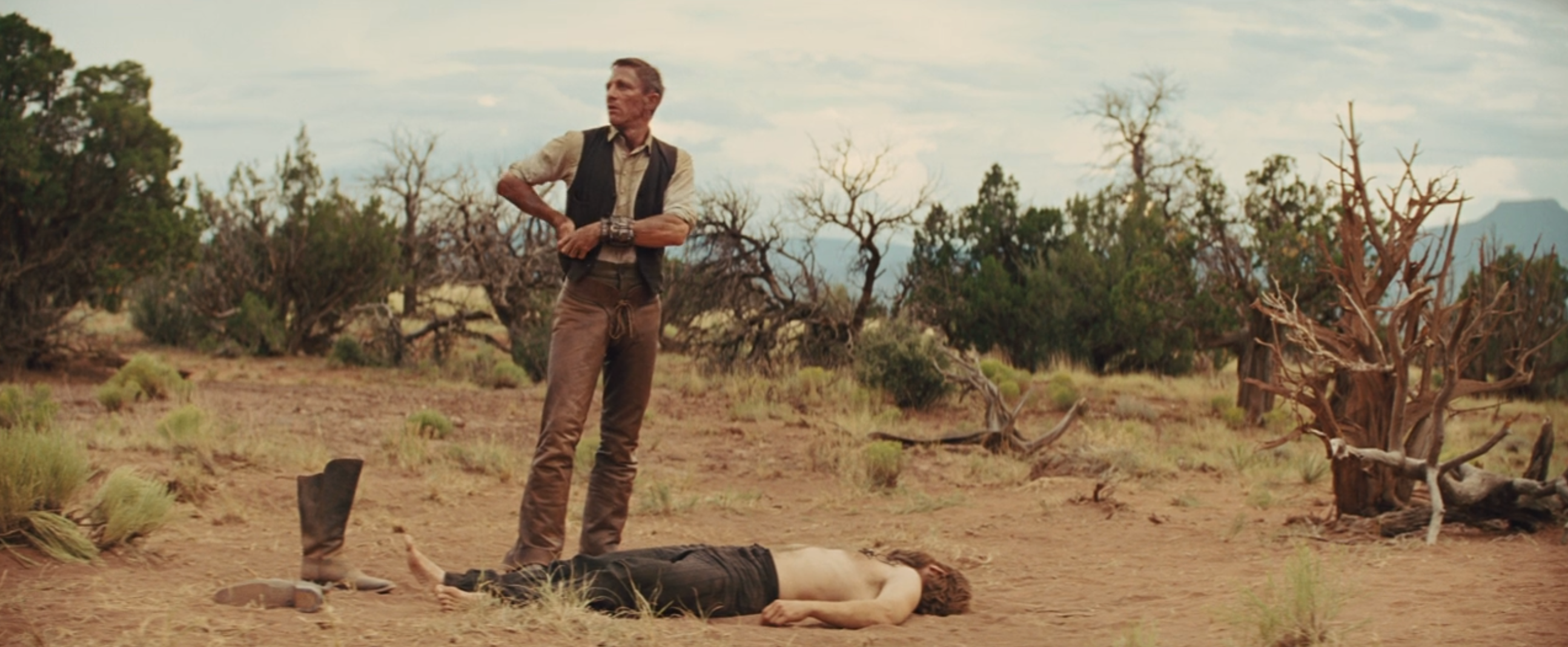 Daniel Craig holsters his gun.