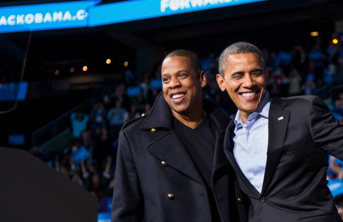 U.S. President Barack Obama stands on stage with rapper Jay Z