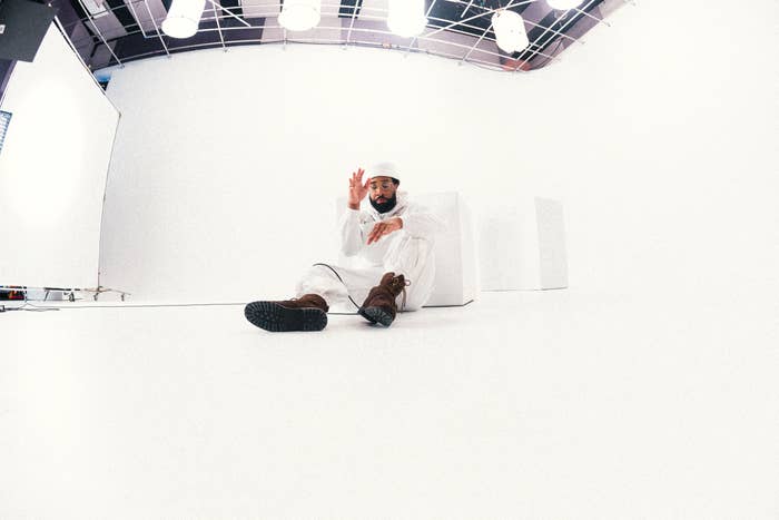 tona in all white sitting in photography studio