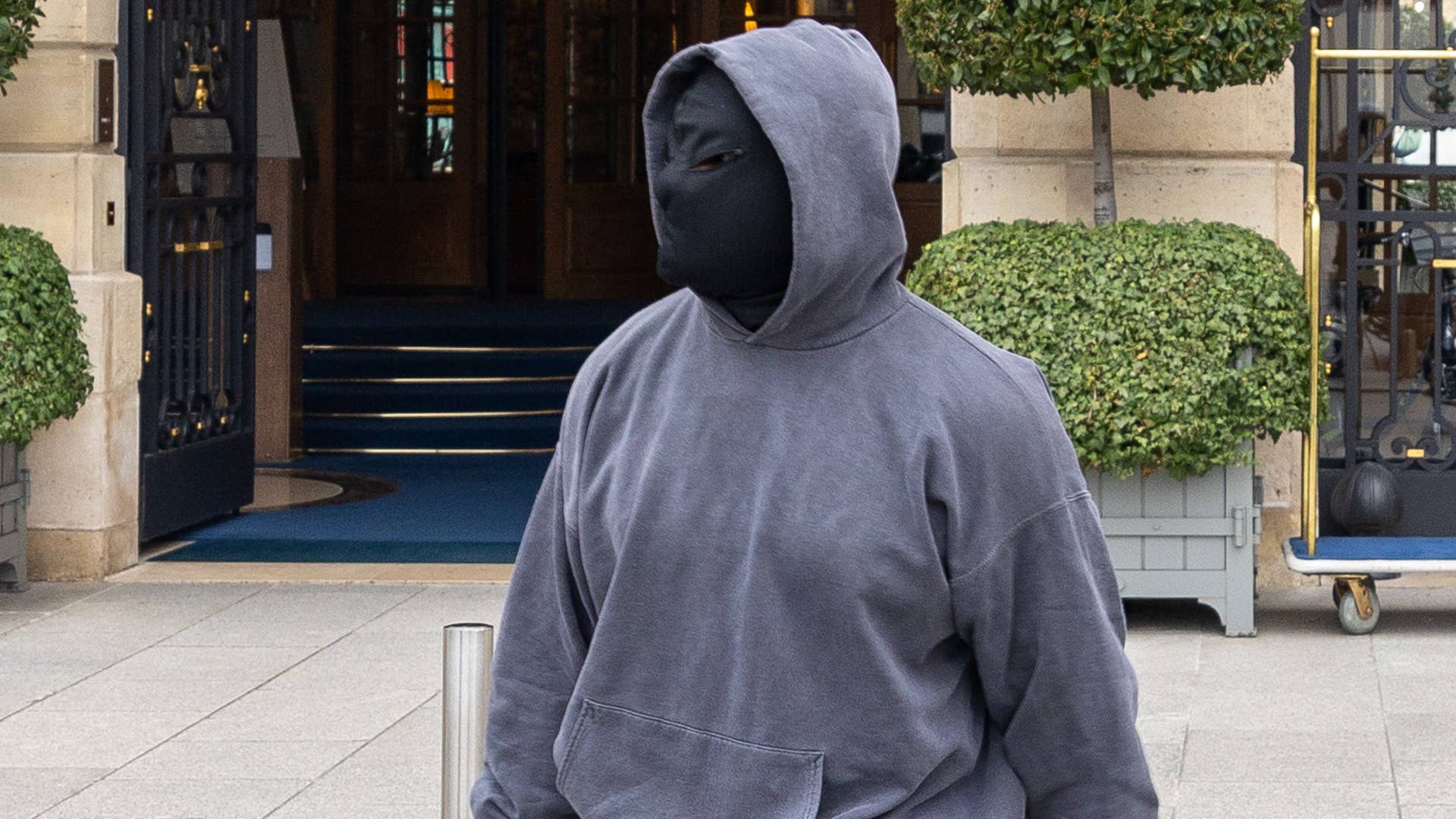 The artist formerly known as Kanye is seen in a mask and hoodie