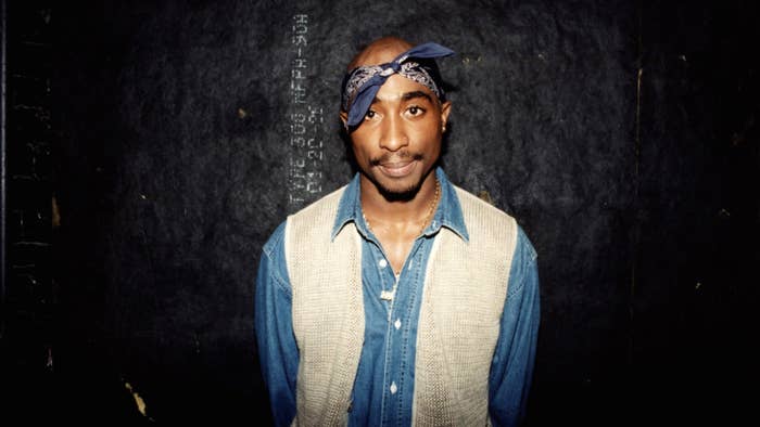 Rapper Tupac Shakur poses for photos backstage after his performance