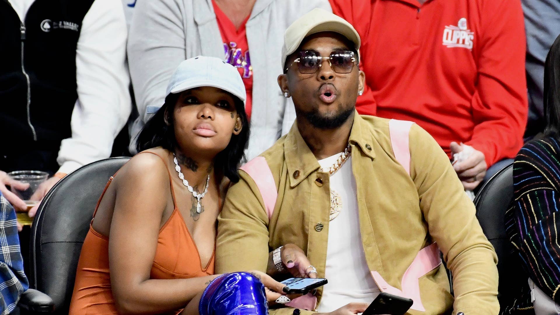 Musician Summer Walker and producer London On Da Track attend a basketball game