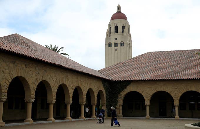 People walk by Hoover Tower on the Stanford University campus.