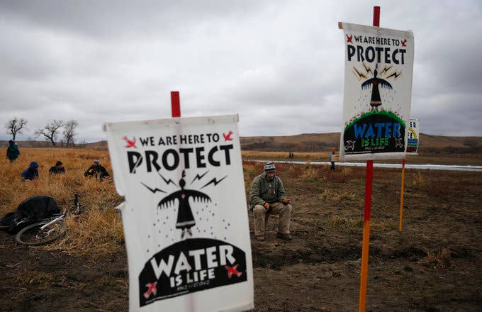Water protectors protest as police line the hill at Standing Rock on Nov. 24, 2016,