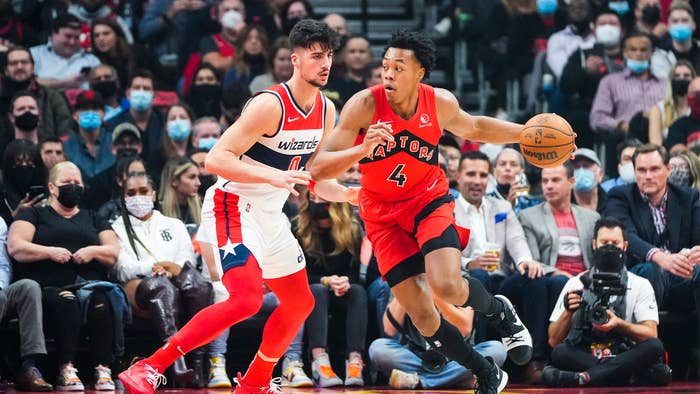 Scottie Barnes #4 of the Toronto Raptors dribbles against Deni Avdija #9 of the Washington Wizards during the first half of their basketball game