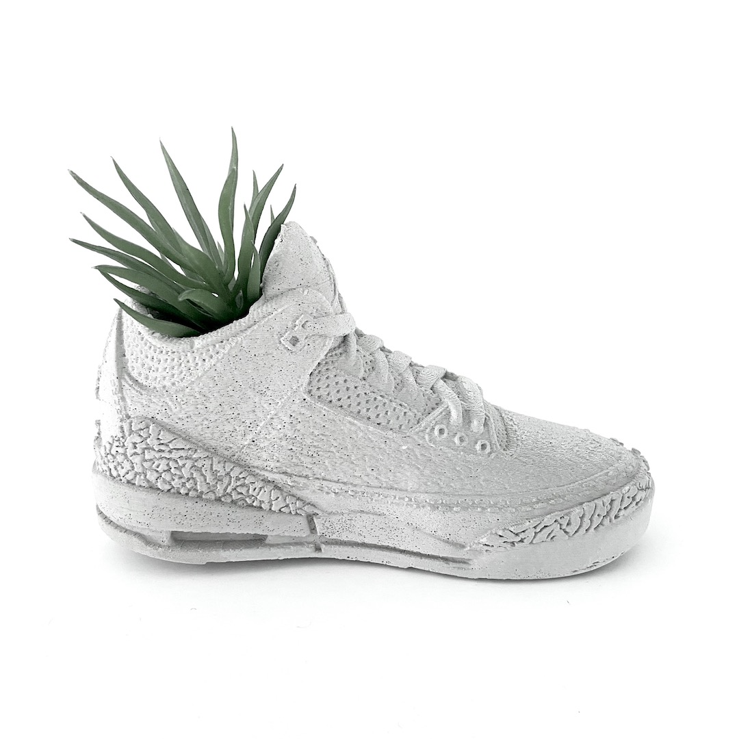 A concrete sneaker planter made by Studio S.